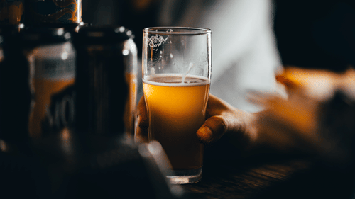A drink placed on a crowded counter
