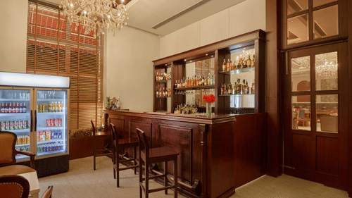 view of the bar counter and a fridge beside it - Royal Kingdom Sarovar Portico, Pilibhit