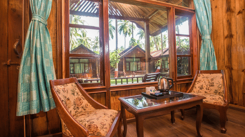 the seating area inside one of the cottages at symphony resorts