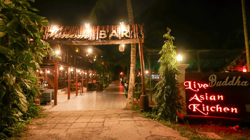 Facade view of the entrance to Venom Bar at Symphony Palms Beach Resort And Spa at night.