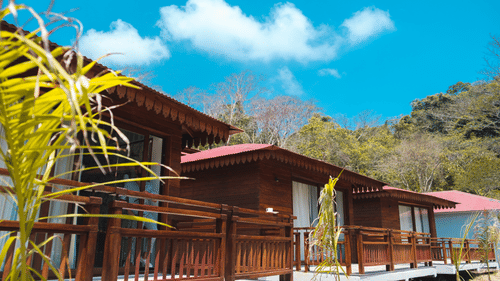 external view of the villas at Symphony Samudra Beachside Jungle Resort And Spa, Port Blair, with trees in the background.