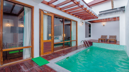 a swimming pool inside the Beach Mansion, an Andaman Luxury Pool Villa, with loungers in the background - Symphony Summer Sand Beach Resort And Spa, Neil Island.