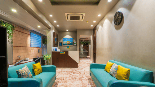 Modern hotel lobby with bright seating, contemporary décor, and warm lighting creating a comfortable and inviting space.