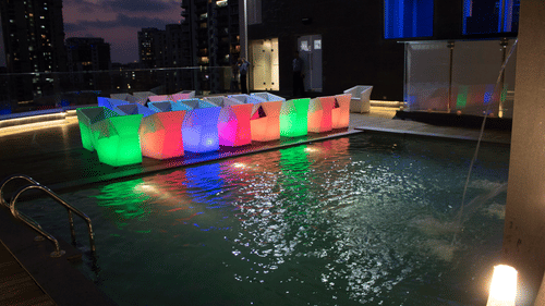 The Empresa Boutique Hotel - the rooftop area with colourful seats beside the swimming pool