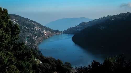 Aerial view of river flowing through the mountains surrounded by lush plants - Ramgarh Bungalows, Nainital.