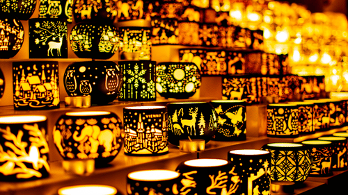 Lit candle holders placed in rows