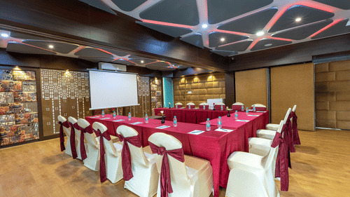 Swayam hall with lots of chairs - The Saibaba Hotel