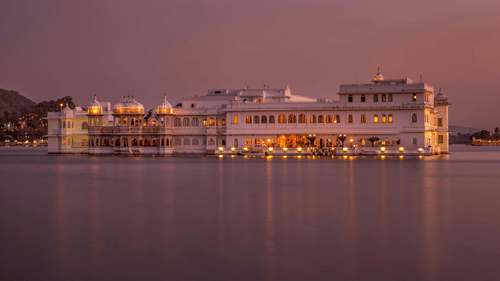 Image of a palace in the middle of a lake at night