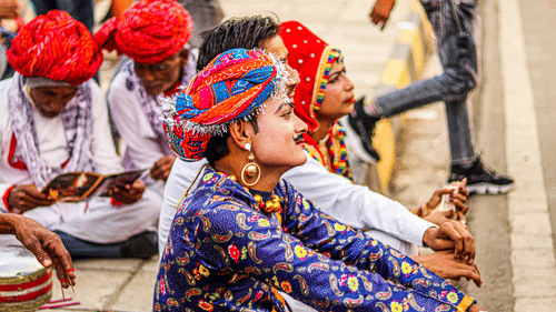 Rajasthani folk artists sitting on the sideways of a road