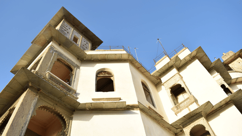 A bottom view of a cream coloured building 