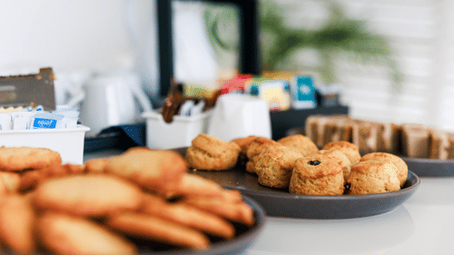 Variety of food served at the table with the focus on one of the biscuit item at The Soco House.