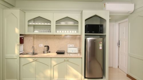 A well-designed kitchen featuring stylish interiors, a refrigerator, and an oven