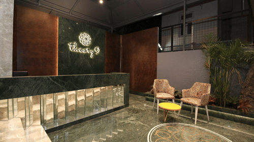 The reception area with two chairs and a small table - theory9 bandra