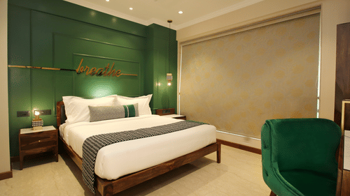 An image of a room with a king bed and modern interiors at theory9 service apartments bandra