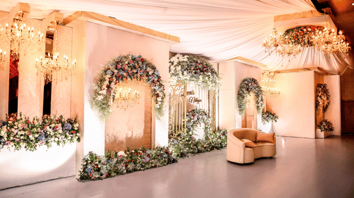 Hall at Uday Palace Convention Centre decorated with fancy clothes and flowers behind a seater