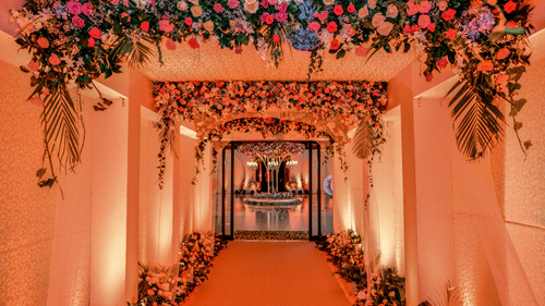 Entrance to the hall of Uday Palace Convention Centre with red carpet on the floor and floral decoration on both sides as well as on the ceiling