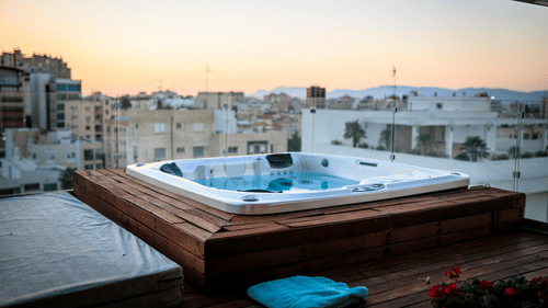 An image of a Jacuzzi on a terrace with the backdrop of buildings