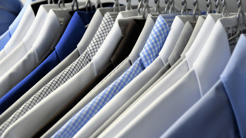 An array of shirts placed on hangers.
