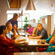 Guests seated together enjoying a meal in the warm dining space at OJ Japanese Restaurant, Featherlite Evoma Hotel.