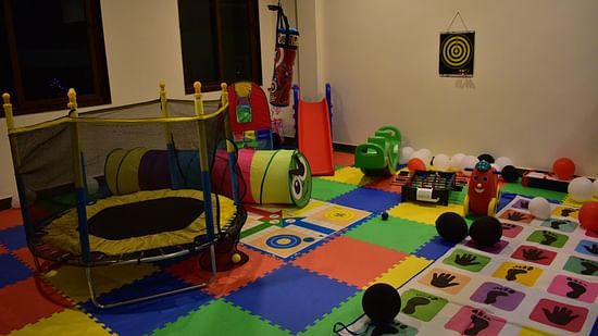 kids play area with toys and miniature rides with colourful flooring - Hotel Montana Vyoo