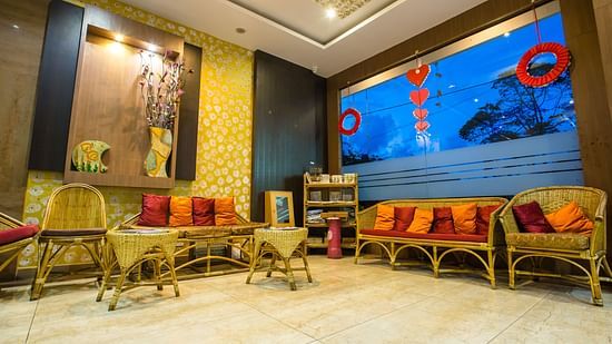 Seating arrangements with a floor to ceiling glass at Burma Banquet Hall - Hotel Shompen