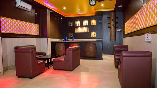 Single seater sofas with coffee tables at Pink Fly - Hotel Shompen