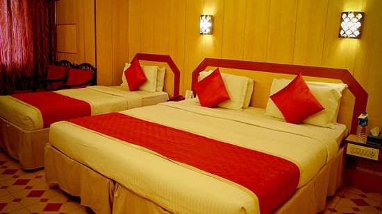 a view of a room furnished with a double bed and a single bed - Hotel Swagath, Bangalore