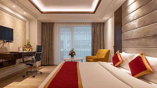 Spacious side view of executive room with a king-size cozy bed and interior lighting at Icon Premier Hotel by Bhagini, Devarabisanahalli