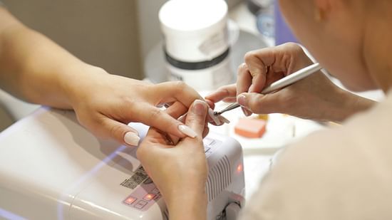 A therapist giving a manicure therapy for a clients hand