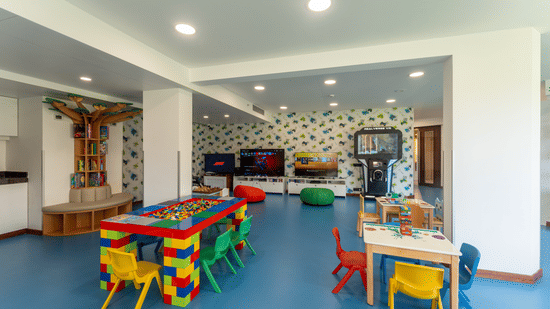 Brightly coloured children's play area with activity tables and small chairs at Kenilworth Resort & Spa, Goa.