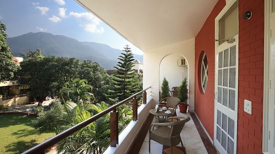 Super Deluxe Room balcony offers a view of the surrounding greenery - Lamrin Boutique Cottages Rishikesh