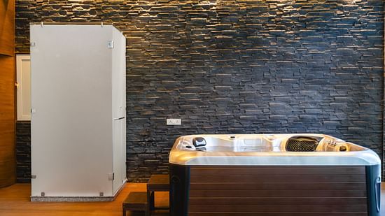 A jacuzzi placed in a room next to a wardrobe at Montclair Ananta, Elite.