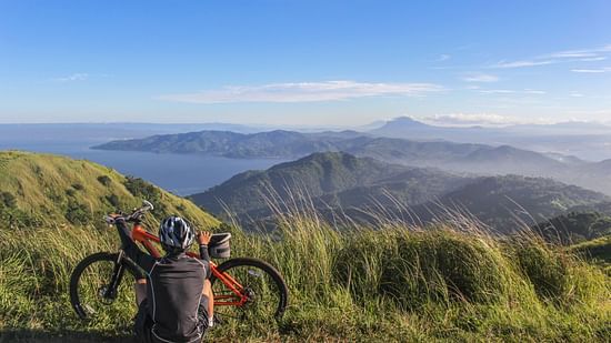 man sitting beside bicycle