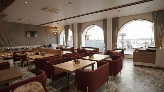 Seating arrangement in the restaurant at Pride Comfort, Dwarka
