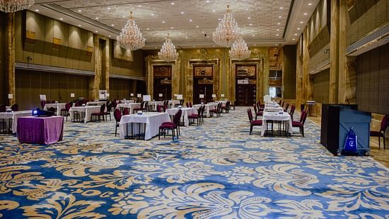 A well decorated banquet hall with chairs and tables