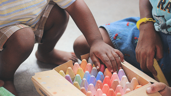 two kids playing with crayons - day picnic resort near Ahmedabad