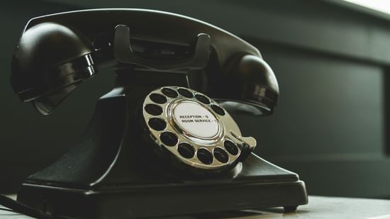A vintage telephone placed on a counter.