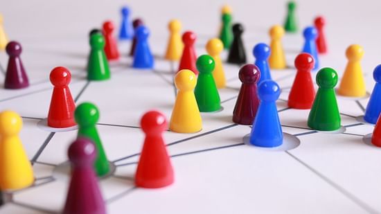 Colorful game pieces forming a network on a board.