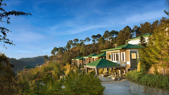 A picturesque mountain resort surrounded by lush trees, featuring stunning views of the mountains and valleys, perfect for a tranquil getaway