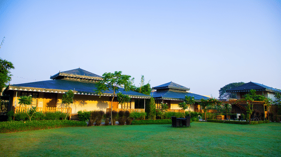 A facade view of The Baagh Ananta Elite, Ranthambore with a lawn in the foreground - Resort Near Ranthambore