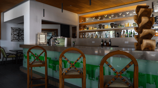 Stylish bar counter with wooden seating and ambient lighting at The Zehneria, Nairobi