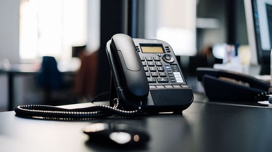 an image of a telephone on a table of a room