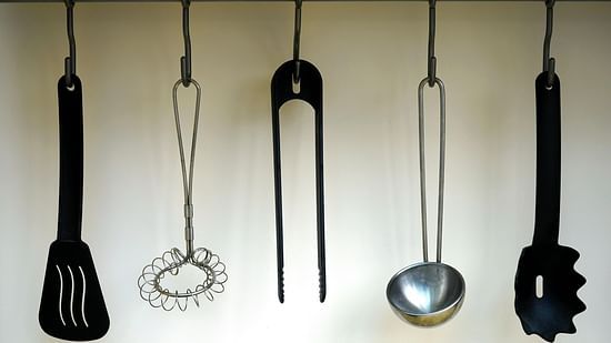 Image of utensils hanging in the kitchen.