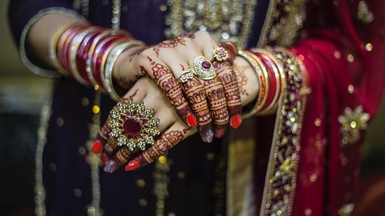 a close up shot of the jewellery that a bride is wearing on her wedding