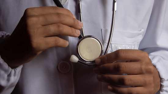 Doctor using a stethoscope during a medical examination.