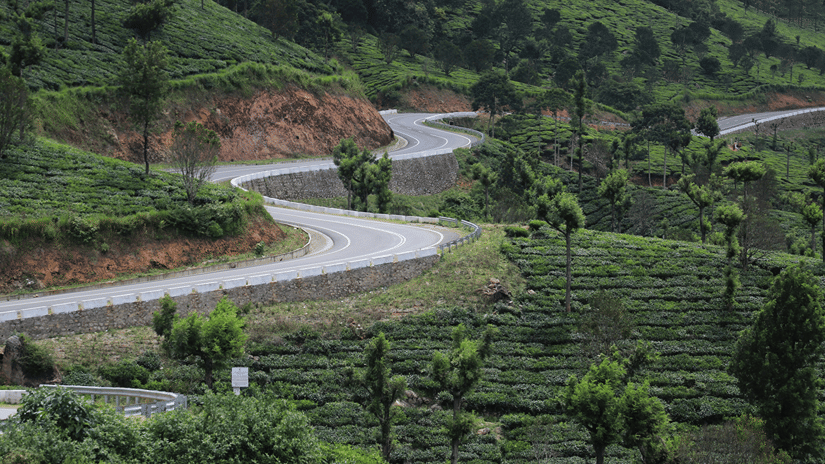 Zigzag roads carved across a mountain slope, often found on a Munnar-to-Thekkady route