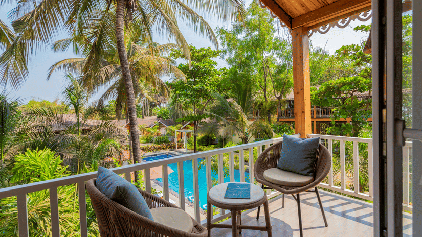 Relaxing resort balcony with wicker chairs, overlooking the cabins Aralea Beach Resort by Stone Wood, Morjim