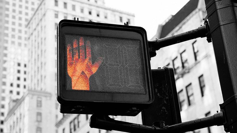 a close up shot of a stop sign with the red light in view
