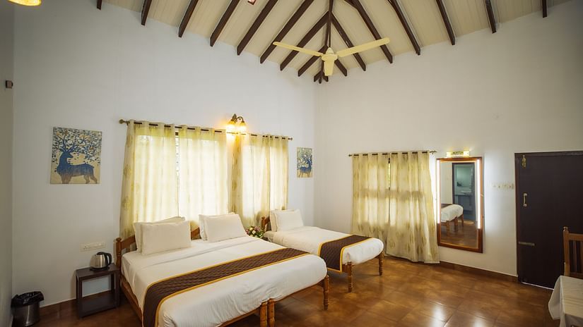 Overview of the deluxe triple room with king and a single bed - Capitol Village Resort, Madikeri