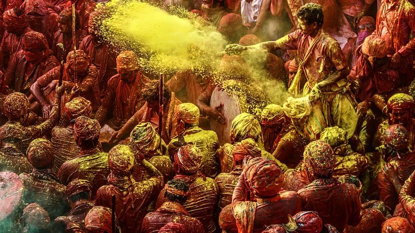 People joyfully celebrate Holi, the Hindu festival of colors, by throwing vibrant powders in the air. 
